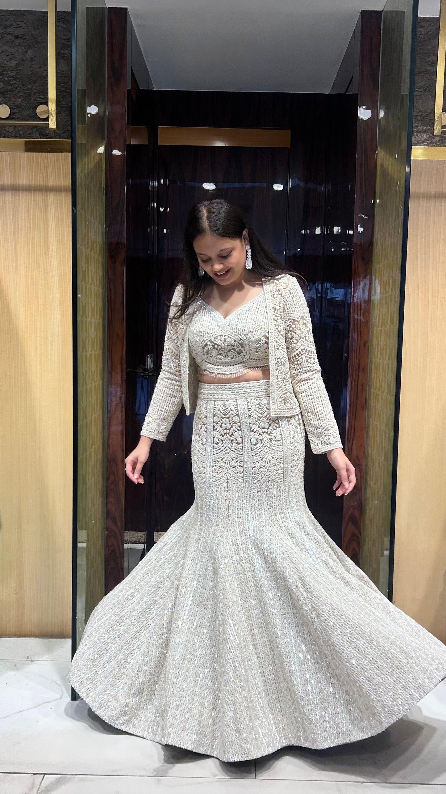 Ivory colour designer inspired semi-bridal fish cut jacket lehenga set.