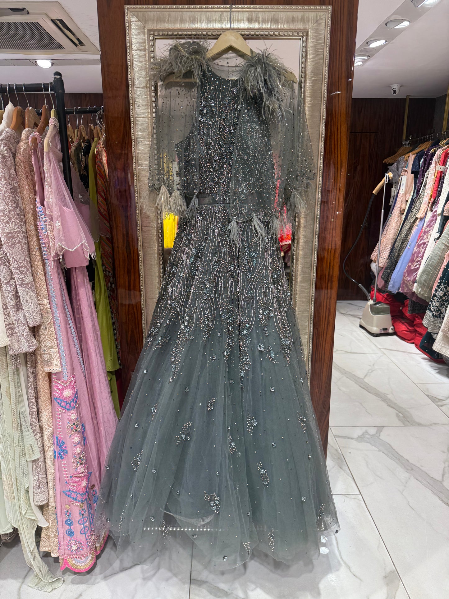 Tiyana gown with sparkling hand embroidery and dramatic feather cape