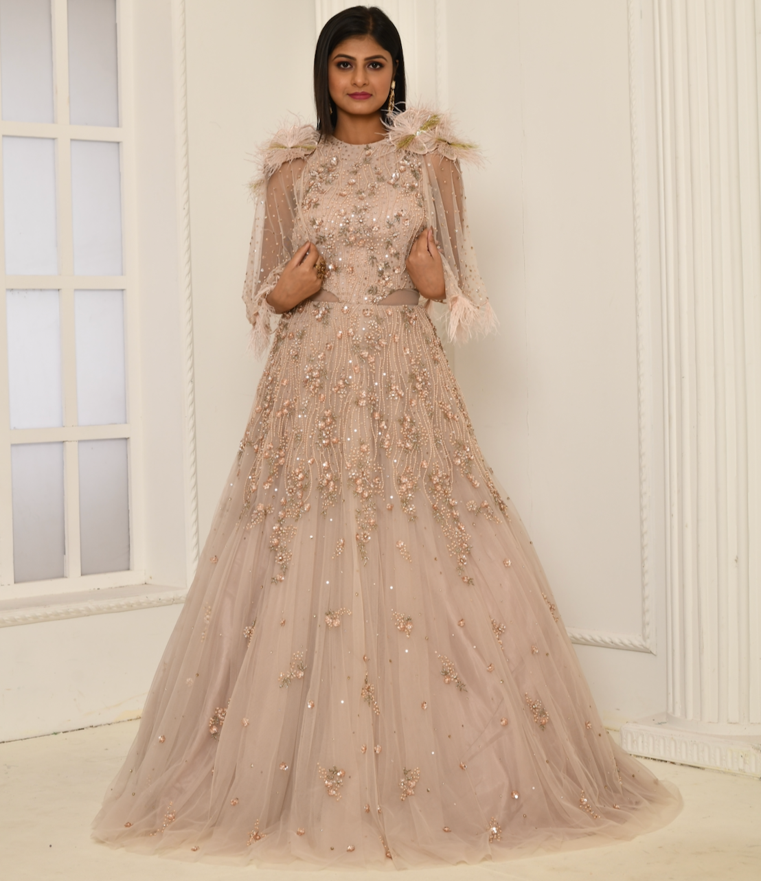 Tiyana feather cape gown in peach with hand embroidery and floral detailing
