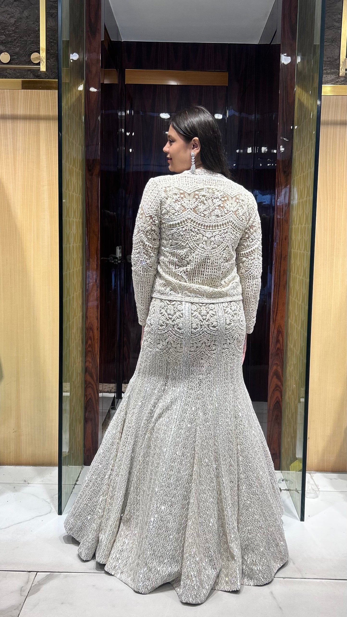 Back view of Zayna net lehenga with crystal hangings