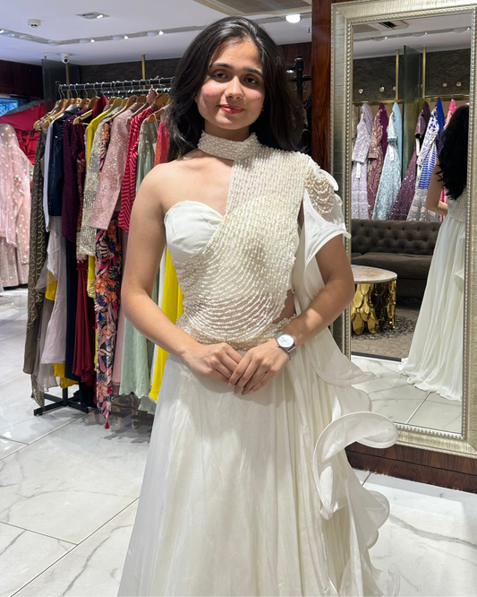 Ivory indo-western lehenga with pearl embellished one-shoulder blouse and ruffle dupatta by House of Ajita