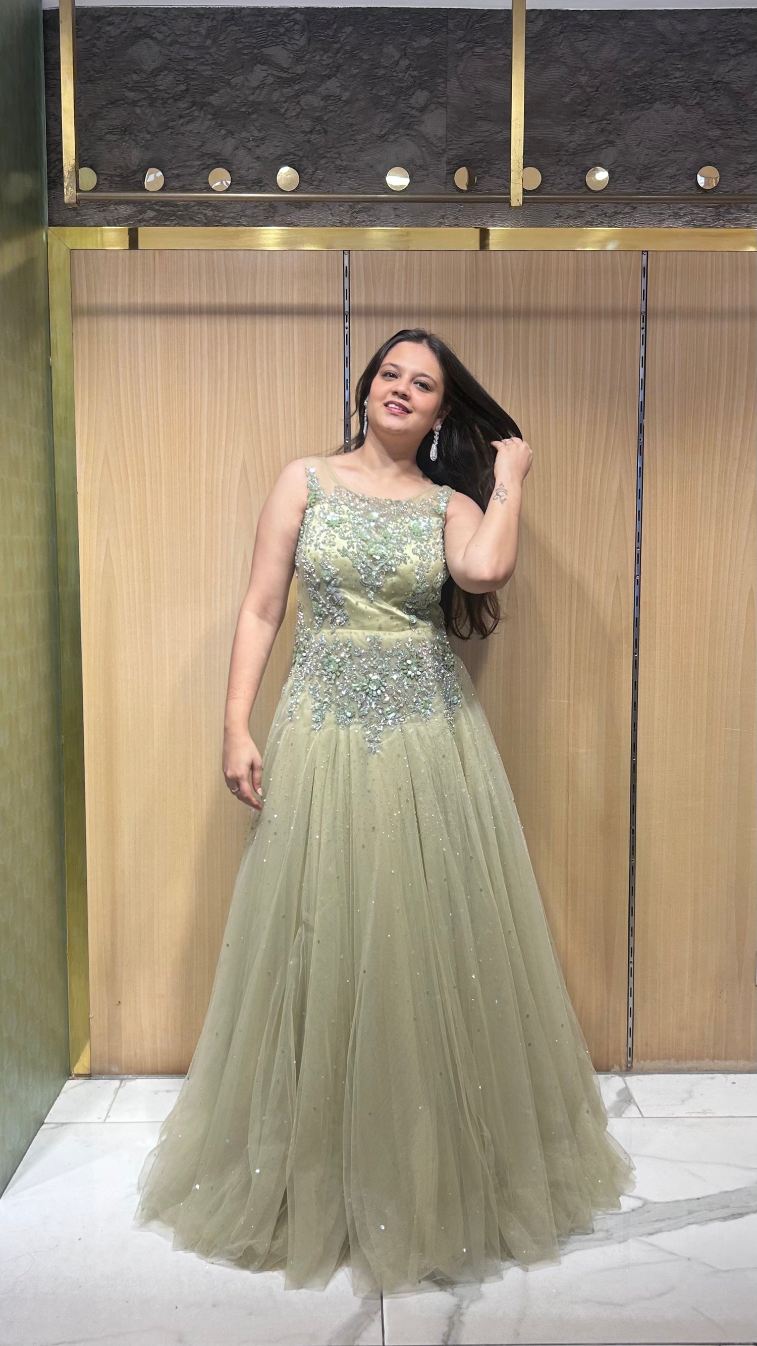 Moira muted khakhi green sequin and stone embroidered sleeveless gown – perfect for bride’s roka, ring ceremony, or reception.