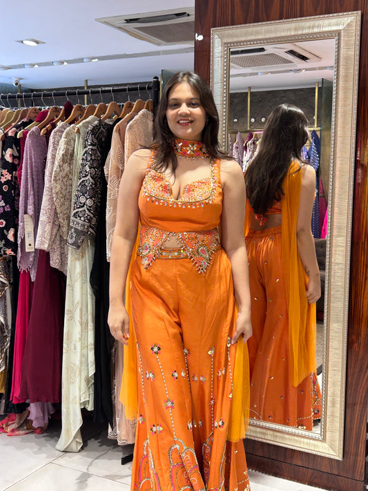 Orange ethnic outfit ideal for festive gatherings and celebrations.
