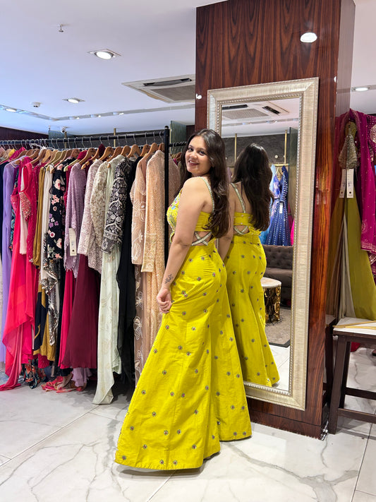 Yellow dress with mirror work ideal for festive occasions.