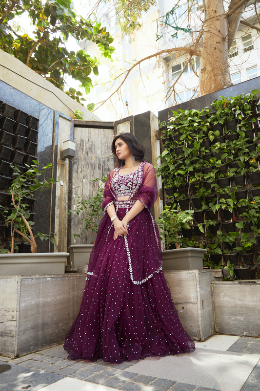 Purple lehenga outdoors suited for engagement and festive events.