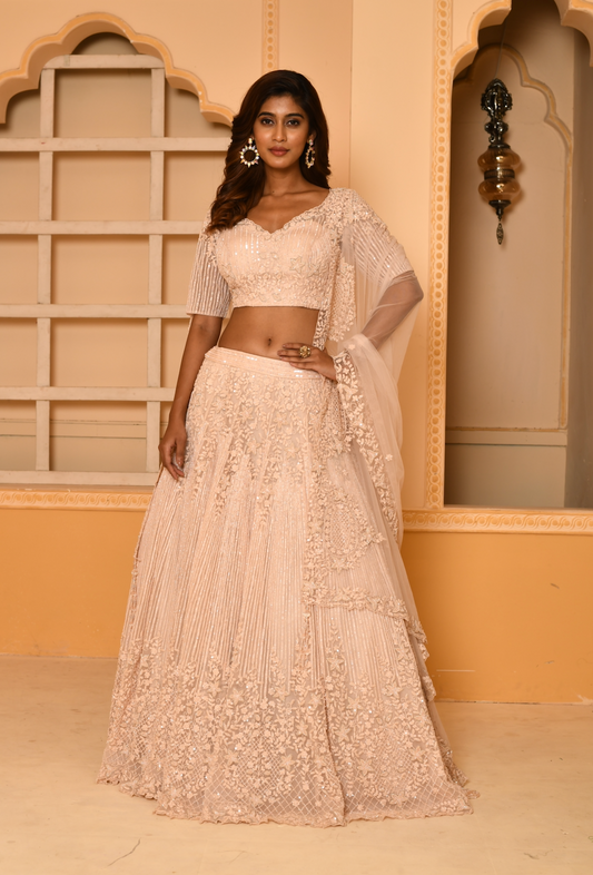Peach embroidered bridal lehenga set perfect for wedding ceremonies.