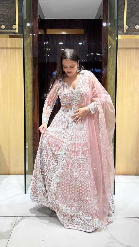 Semi-bridal Peachish-Pink net lehenga with pearl and cut dana hand embroidery