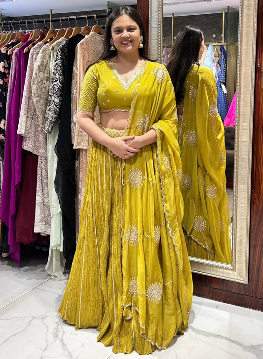 Yellow lehenga choli suited for traditional wedding functions.