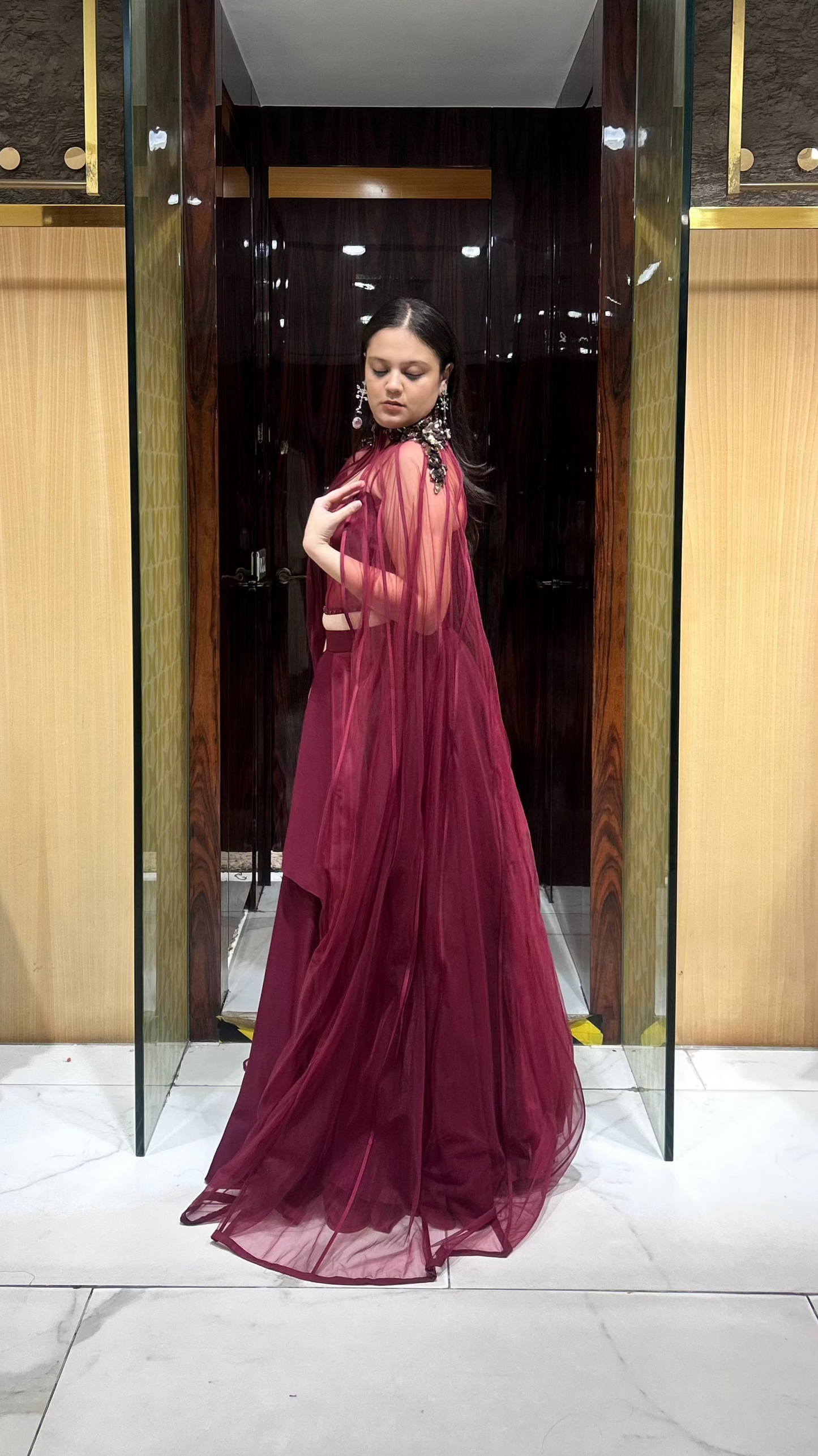 House of Ajita designer maroon cape lehenga set with layered skirt and corset blouse