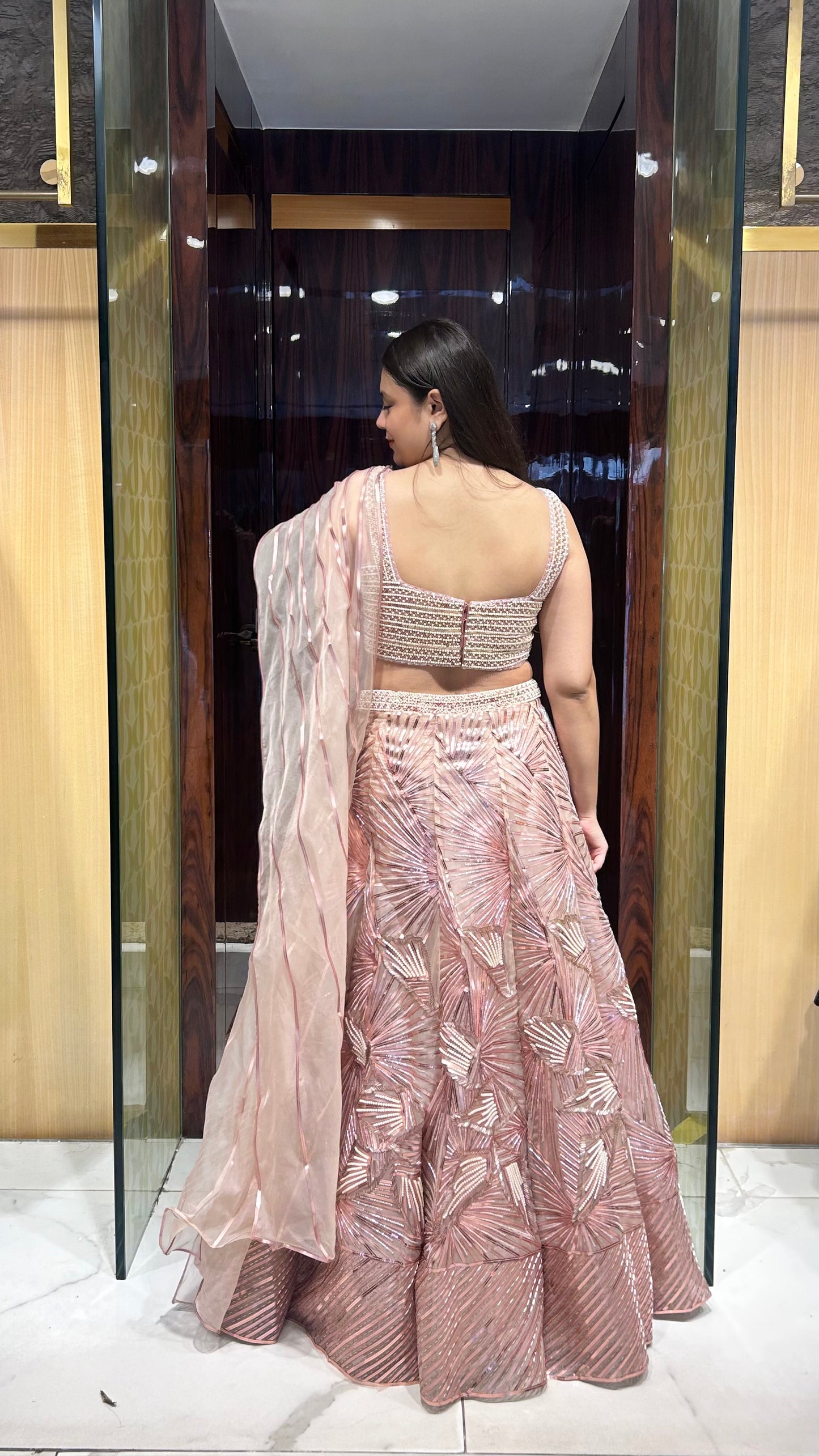 Back image - Peach designer lehenga with leather patch embroidery