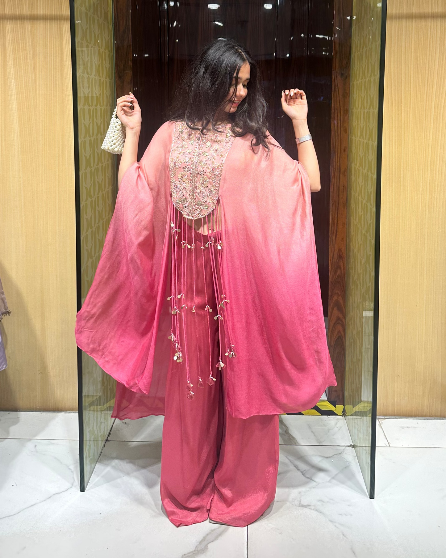 Indo-western kaftan set with pants and a bustier. Shaded peachish pink with fun hangings. Perfect for mehendi, carnival, haldi