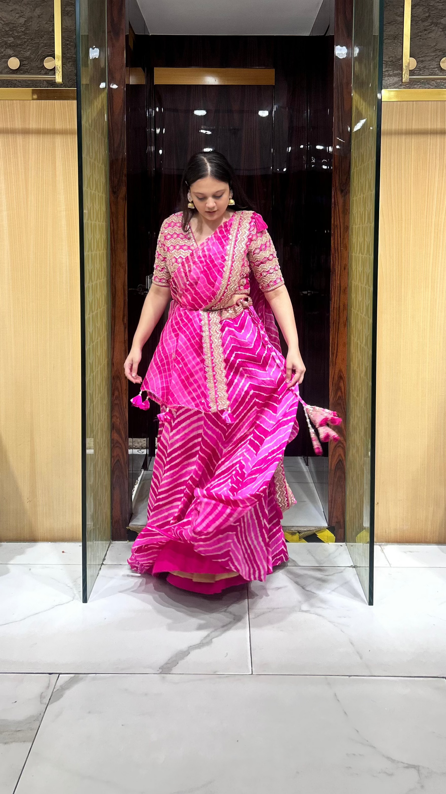 Traditional pink leheriya lehenga with embroidered dupatta and thread hangings