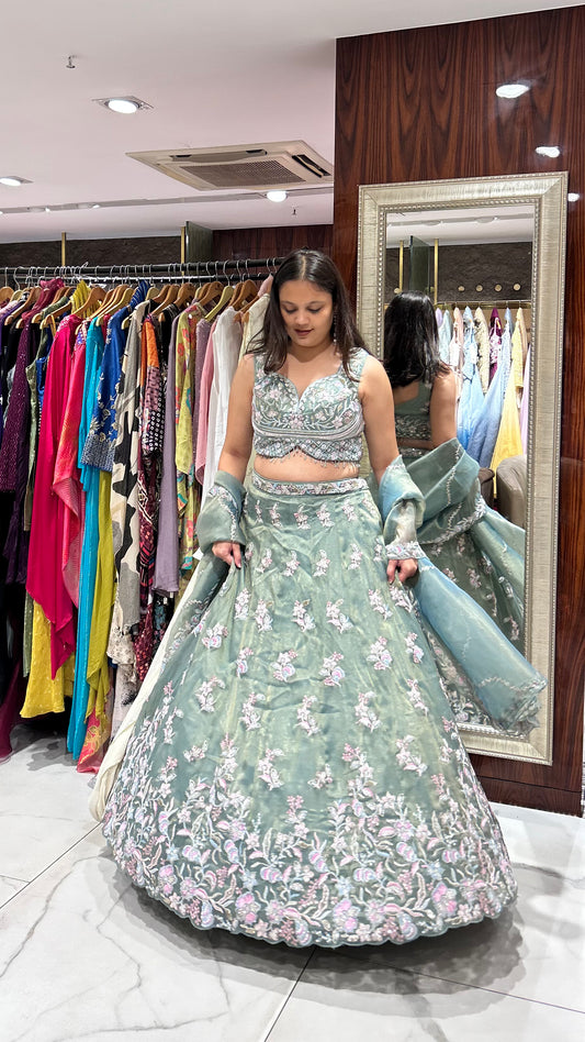 Green with multicoloured lehenga perfect for mehendi, carnivals, or wedding celebrations for the bride or her sister.