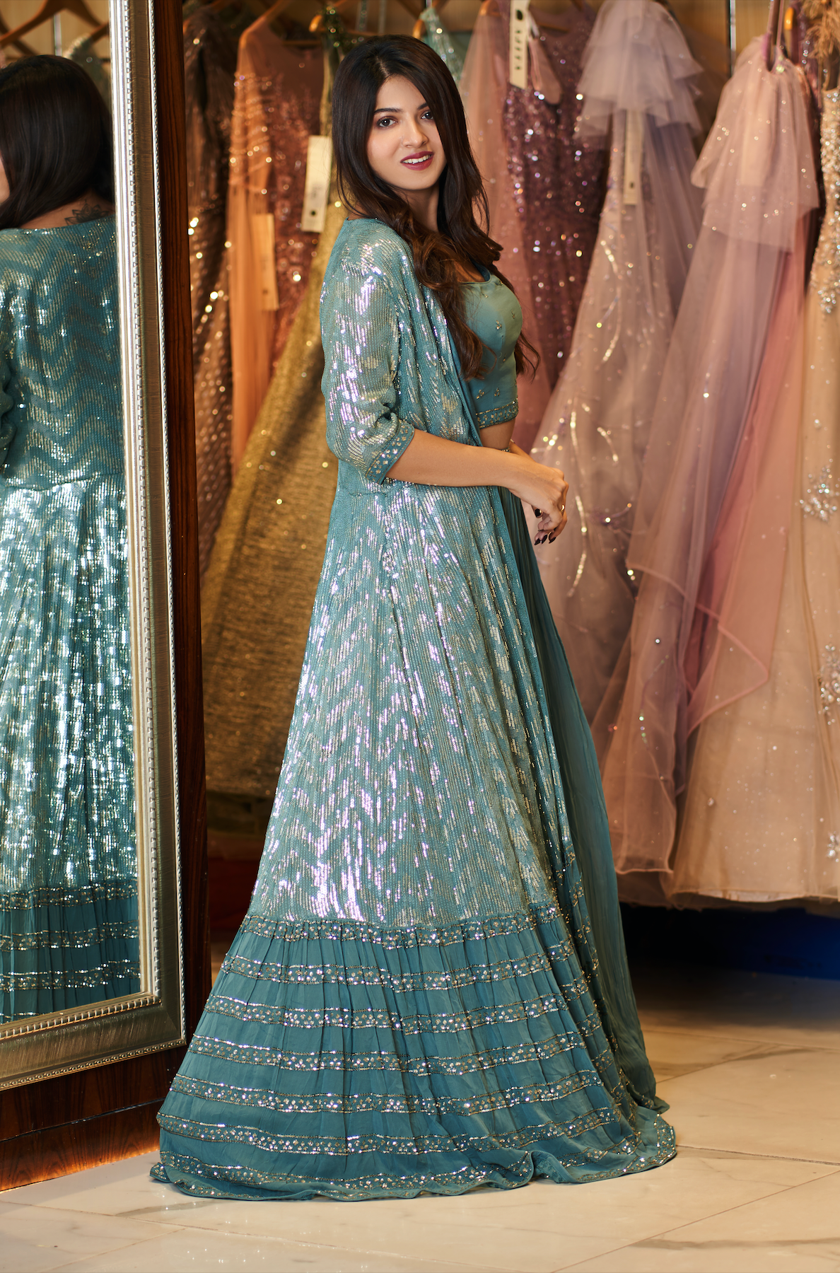 Long silver sequin jacket with frill hem worn over lehenga