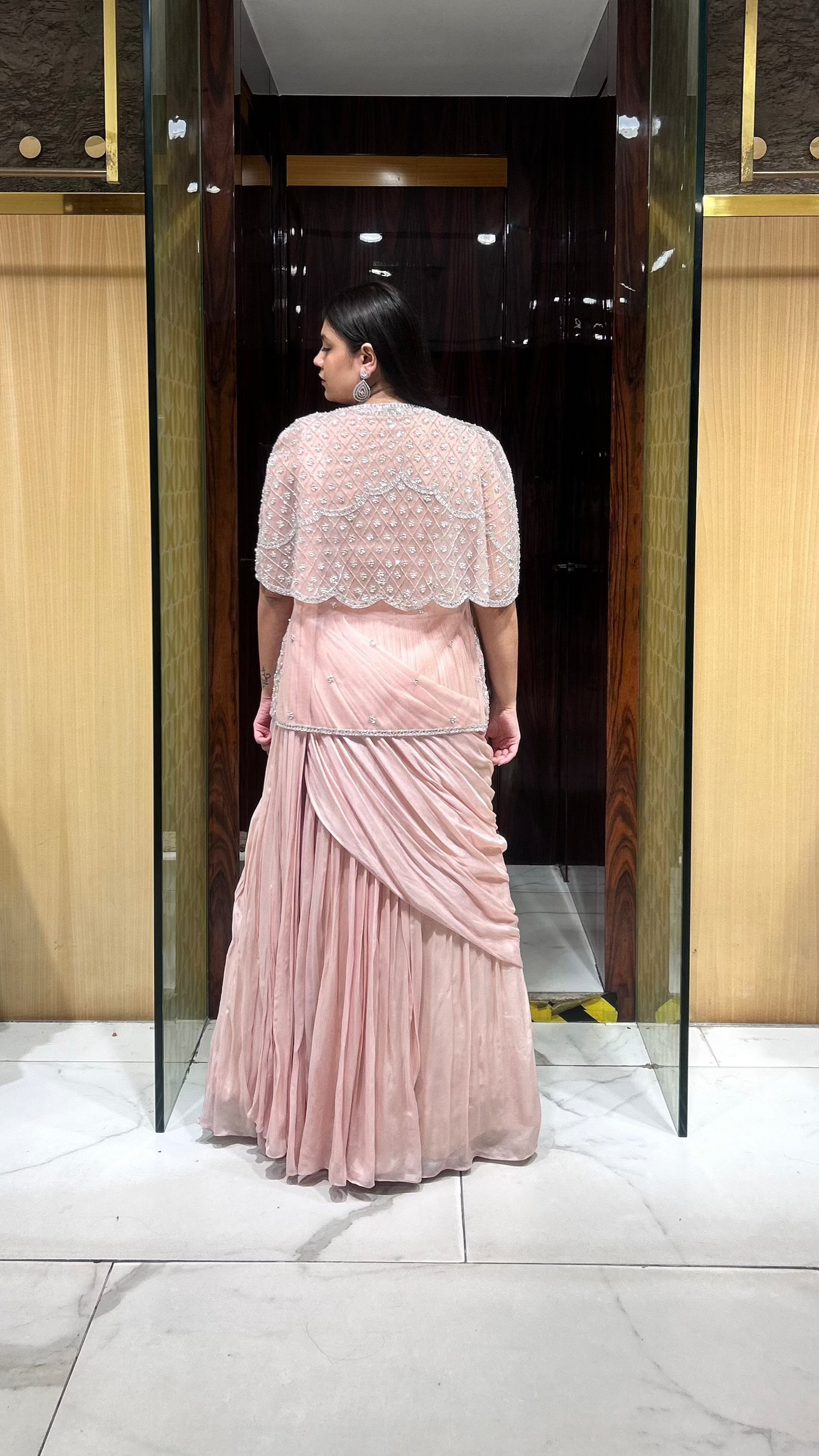Stylish wedding guest lehenga in peach with embroidered jacket for the perfect layered look