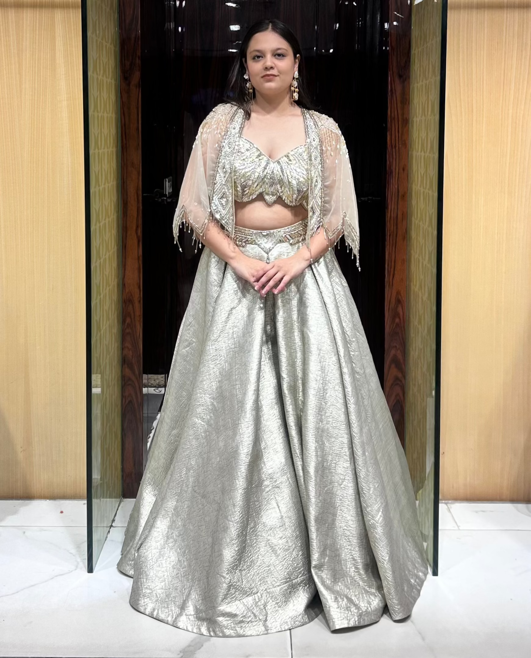 Sophia grey-gold lehenga with strappy blouse and scalloped cape