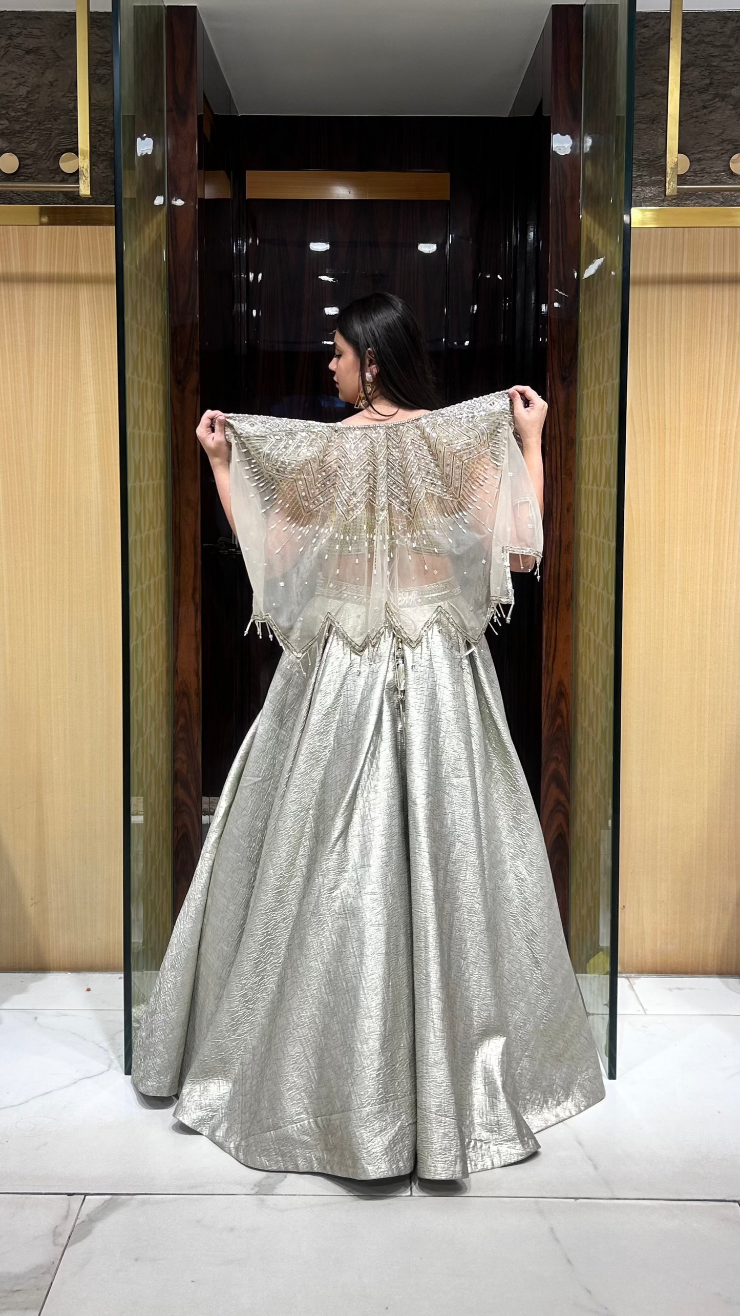 Glamorous bridesmaid look with cape and embellished blouse